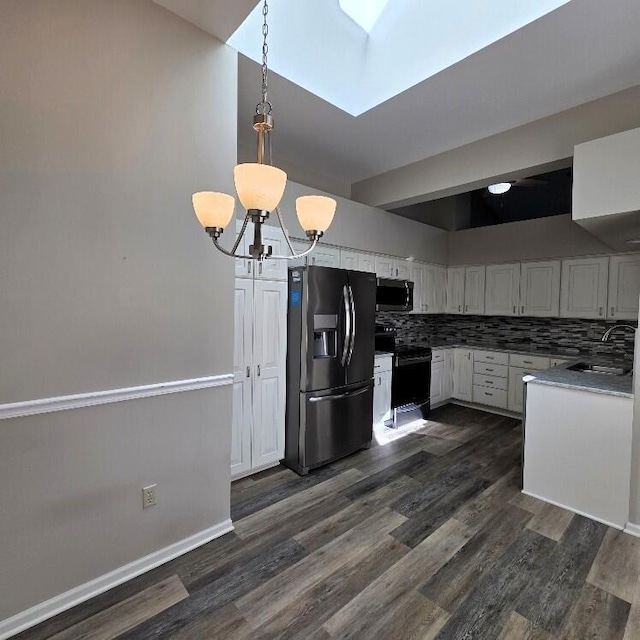 176 Long Rapids Rd, Alpena, MI 49707 - kitchen featuring appliances with stainless steel finishes, a chandelier, a skylight, white cabinetry, and backsplash