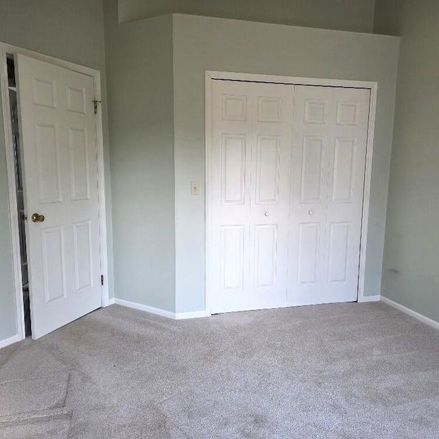 176 Long Rapids Rd, Alpena, MI 49707 - unfurnished bedroom featuring carpet flooring and a closet