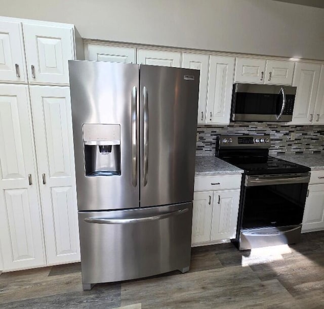 176 Long Rapids Rd, Alpena, MI 49707 - kitchen with stainless steel appliances, dark wood finished floors, white cabinets, decorative backsplash, and light stone countertops