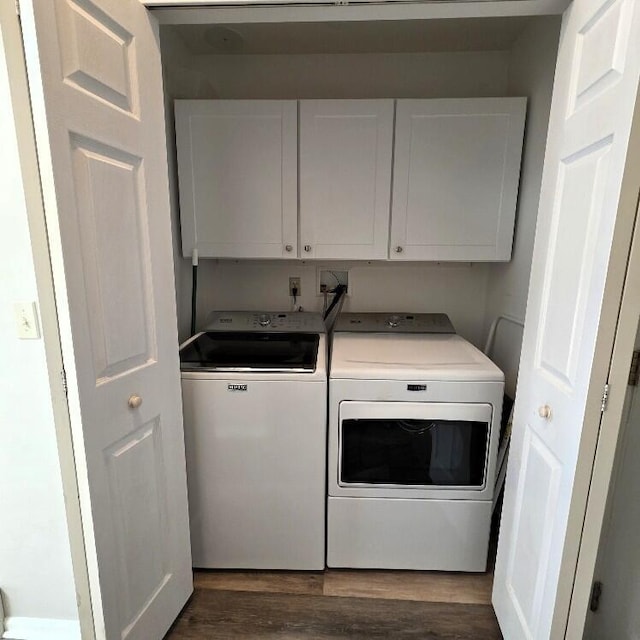 176 Long Rapids Rd, Alpena, MI 49707 - laundry area featuring cabinet space, separate washer and dryer, and dark wood-style floors