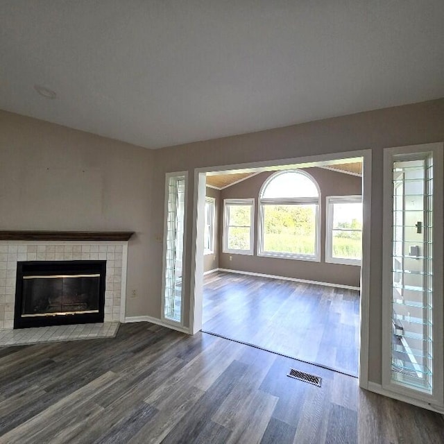 176 Long Rapids Rd, Alpena, MI 49707 - unfurnished living room featuring wood finished floors and a fireplace