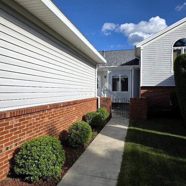 176 Long Rapids Rd, Alpena, MI 49707 - view of exterior entry with brick siding