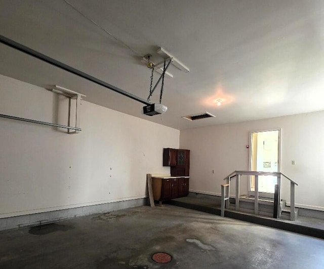 176 Long Rapids Rd, Alpena, MI 49707 - garage featuring a garage door opener