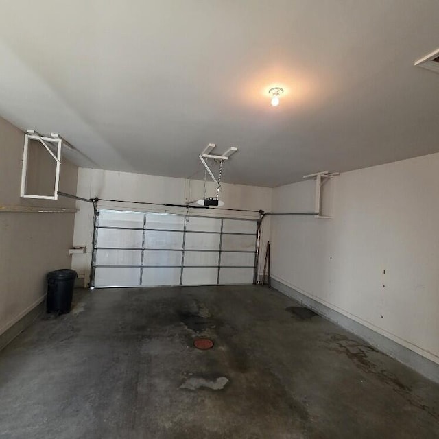 176 Long Rapids Rd, Alpena, MI 49707 - garage featuring baseboards and a garage door opener
