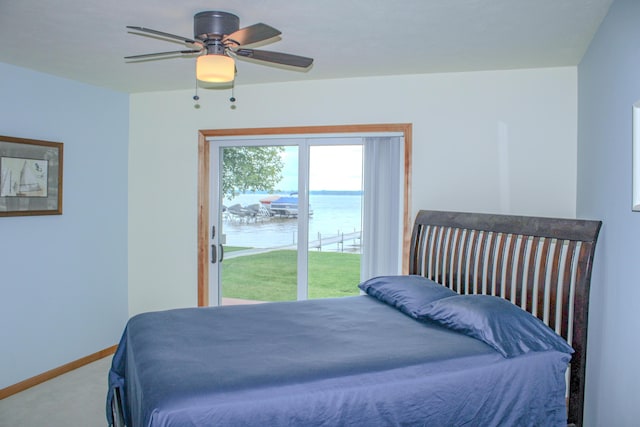 11920 W Shore Dr, Houghton Lake, MI 48629 - carpeted bedroom featuring access to outside, a water view, and ceiling fan