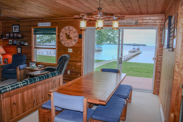 11920 W Shore Dr, Houghton Lake, MI 48629 - carpeted dining area featuring wood ceiling, a water view, and wood walls