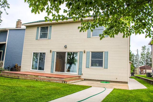 11920 W Shore Dr, Houghton Lake, MI 48629 - rear view of property with a yard, a wooden deck, and a patio