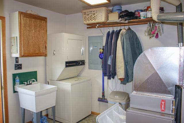 11920 W Shore Dr, Houghton Lake, MI 48629 - laundry room with stacked washer / dryer, cabinet space, electric panel, and heating unit