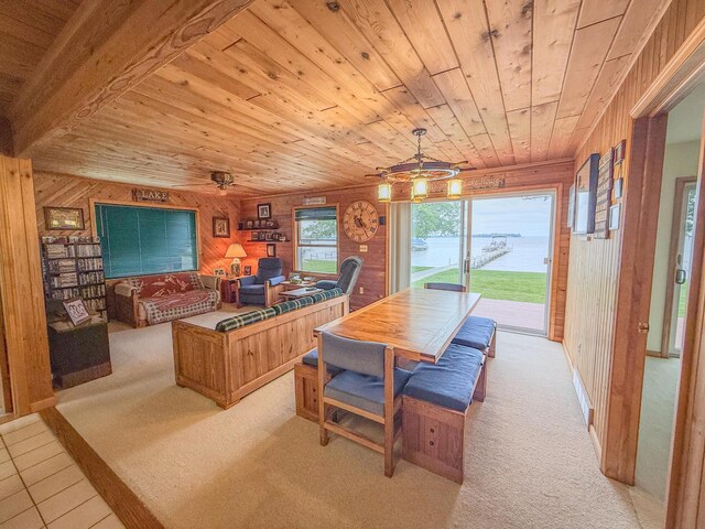 11920 W Shore Dr, Houghton Lake, MI 48629 - dining room with wooden walls, wood ceiling, light carpet, a ceiling fan, and a water view