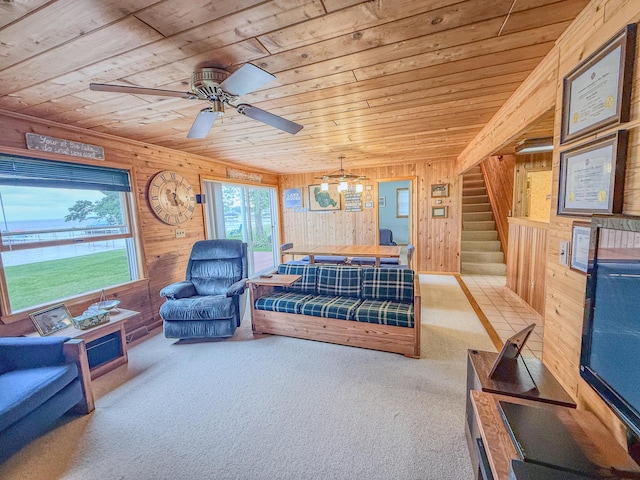 11920 W Shore Dr, Houghton Lake, MI 48629 - living area featuring wood ceiling, wooden walls, stairs, a ceiling fan, and carpet