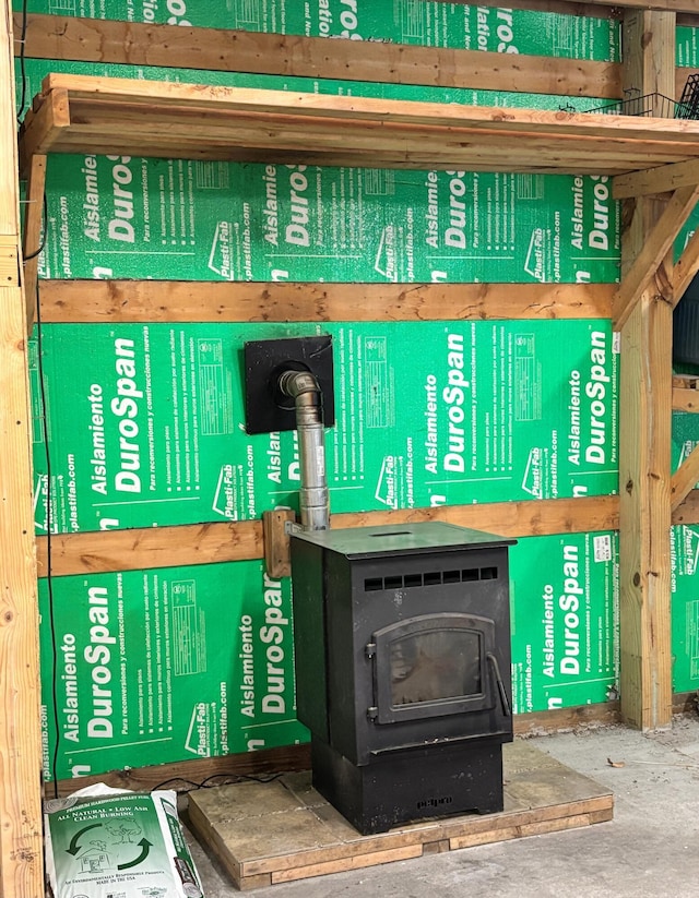10279 N Sherman Rd, Frederic, MI 49733 - detailed view of a wood stove and concrete flooring