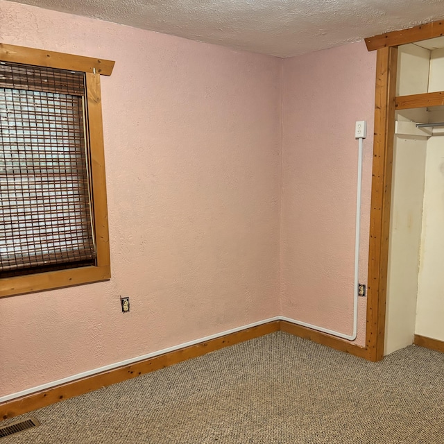 10279 N Sherman Rd, Frederic, MI 49733 - unfurnished bedroom featuring carpet flooring and a textured ceiling