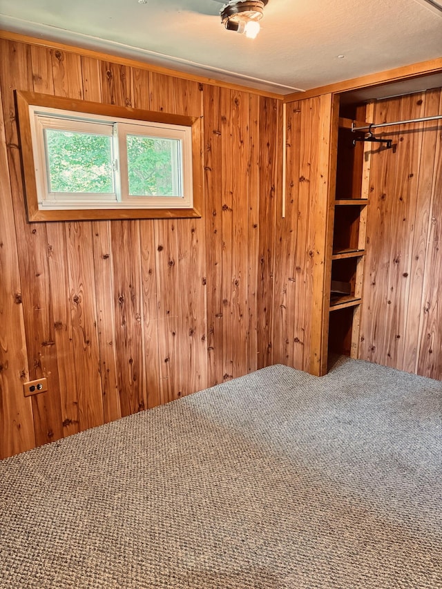 10279 N Sherman Rd, Frederic, MI 49733 - unfurnished bedroom with carpet, wooden walls, and a closet