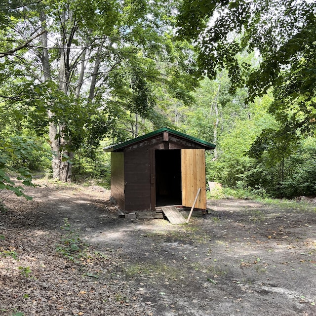10279 N Sherman Rd, Frederic, MI 49733 - view of shed featuring a wooded view