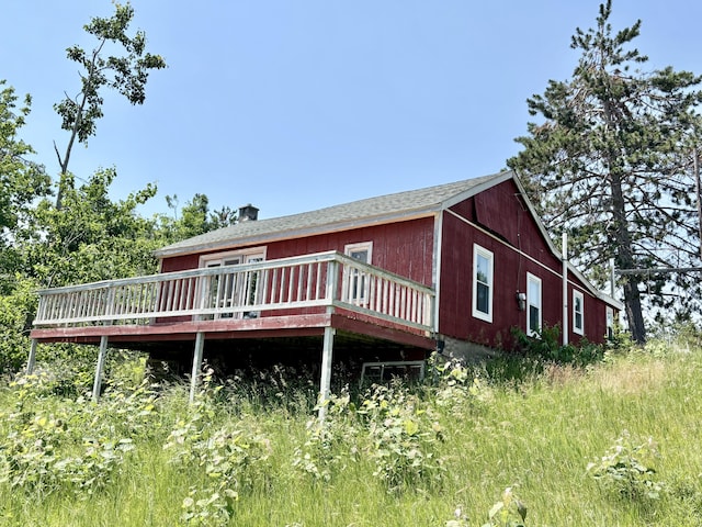 1950 Highbank Trl, Lewiston, MI 49756 - view of front facade featuring a wooden deck
