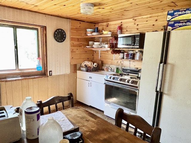 1950 Highbank Trl, Lewiston, MI 49756 - kitchen featuring white appliances, wood walls, wood ceiling, open shelves, and white cabinets