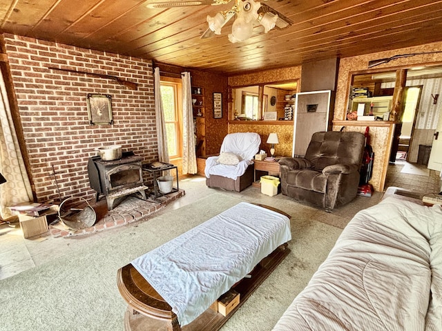 1950 Highbank Trl, Lewiston, MI 49756 - living room featuring a wood stove, wooden ceiling, carpet flooring, and ceiling fan