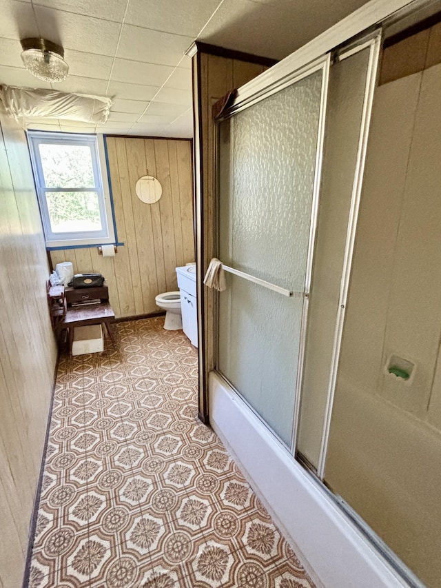 1950 Highbank Trl, Lewiston, MI 49756 - bathroom with wood walls, tile patterned floors, and shower / bath combination with glass door