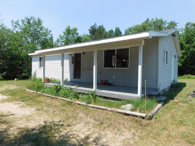 4616 Martin Dr, Frederic, MI 49733 - view of front of property with covered porch and a front lawn