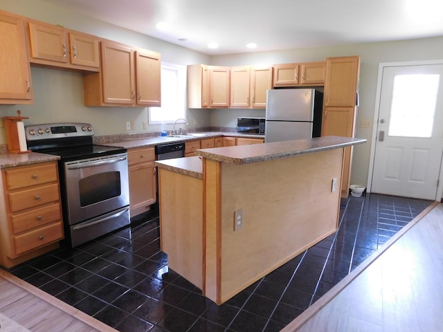 4616 Martin Dr, Frederic, MI 49733 - kitchen featuring appliances with stainless steel finishes, light brown cabinetry, a center island, recessed lighting, and dark tile patterned flooring