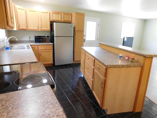 4616 Martin Dr, Frederic, MI 49733 - kitchen with freestanding refrigerator, light brown cabinetry, electric stove, a center island, and light countertops