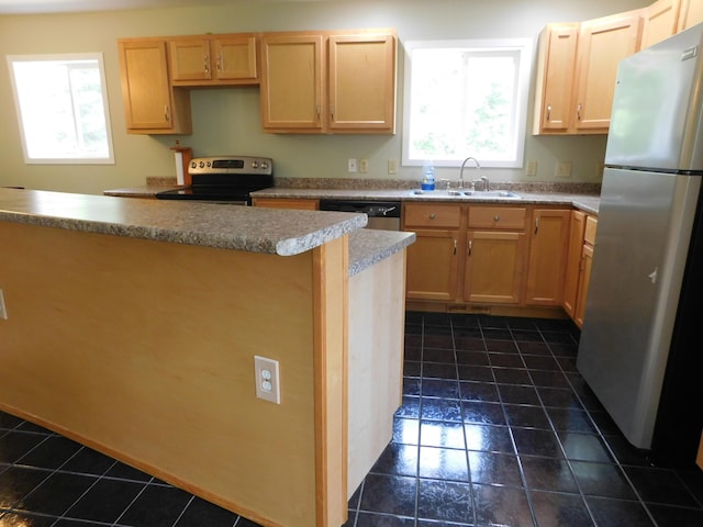 4616 Martin Dr, Frederic, MI 49733 - kitchen featuring stainless steel appliances, dark tile patterned flooring, and light brown cabinetry
