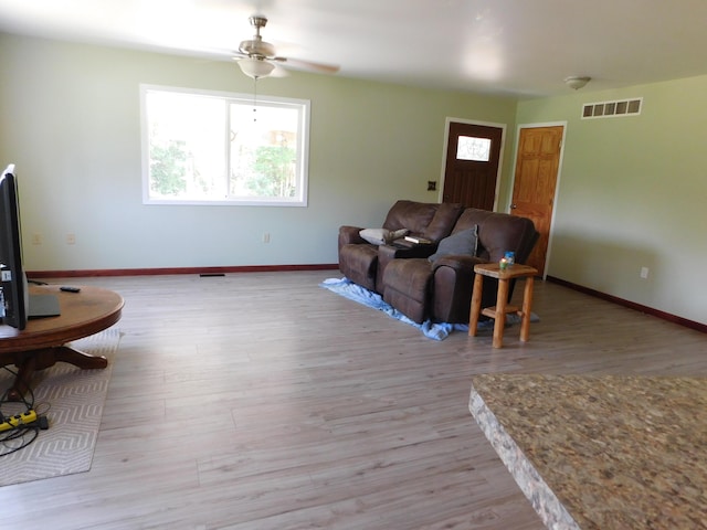 4616 Martin Dr, Frederic, MI 49733 - living room featuring a ceiling fan and light wood-type flooring