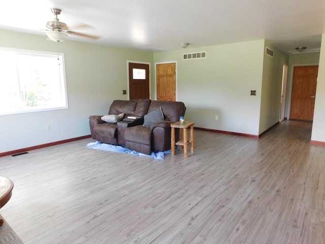 4616 Martin Dr, Frederic, MI 49733 - living room featuring light wood-style flooring, plenty of natural light, and ceiling fan