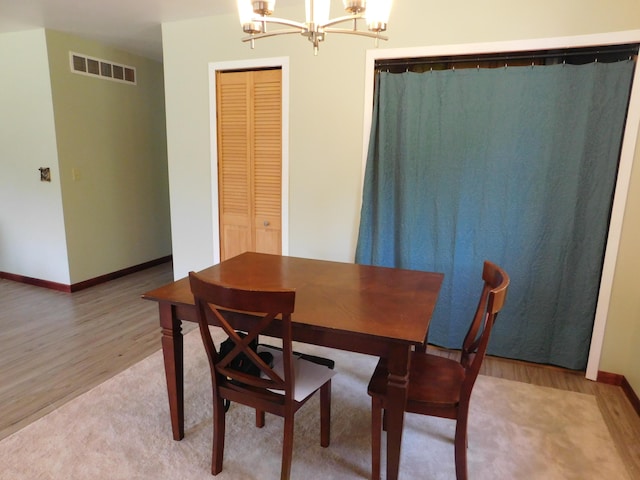 4616 Martin Dr, Frederic, MI 49733 - dining area featuring a chandelier and light wood-type flooring