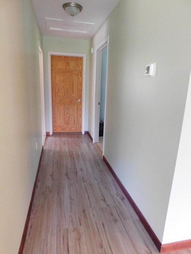 4616 Martin Dr, Frederic, MI 49733 - hallway featuring light wood finished floors and attic access