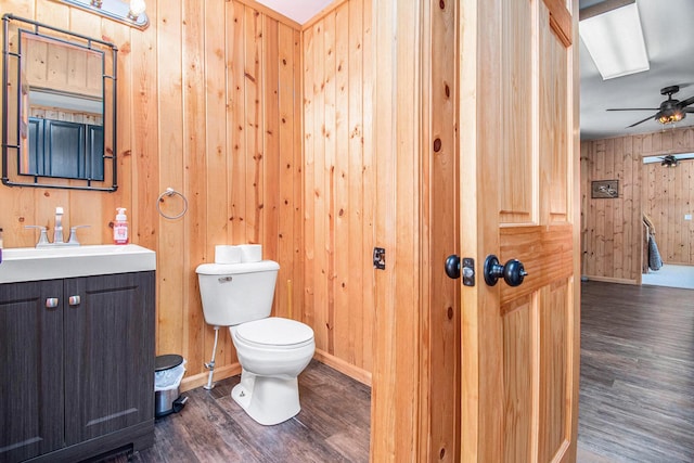 2145 Mustang St, Saint Helen, MI 48656 - bathroom featuring wooden walls, wood finished floors, vanity, and ceiling fan