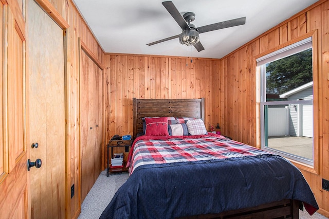 2145 Mustang St, Saint Helen, MI 48656 - bedroom featuring carpet floors, wooden walls, and ceiling fan