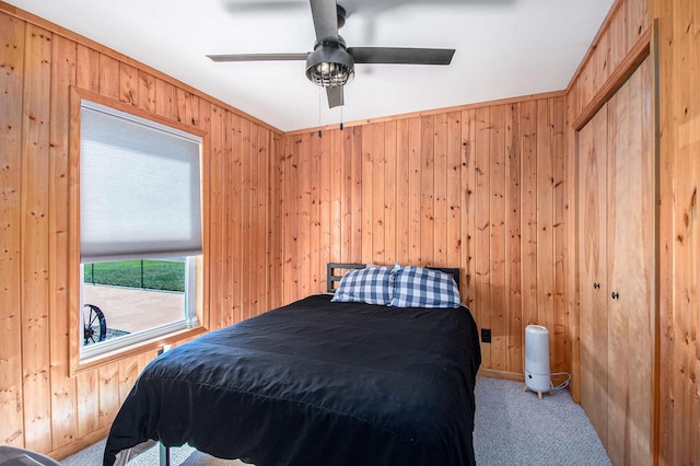 2145 Mustang St, Saint Helen, MI 48656 - carpeted bedroom featuring wooden walls and a ceiling fan