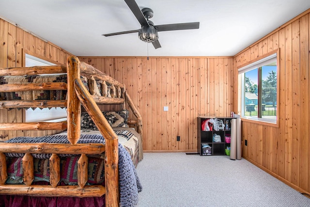 2145 Mustang St, Saint Helen, MI 48656 - bedroom featuring wood walls, carpet flooring, and ceiling fan