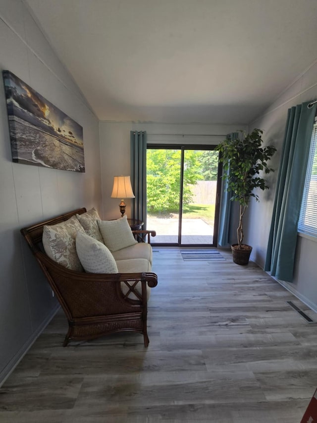506 S N St, Alpena, MI 49707 - living area featuring vaulted ceiling and wood finished floors