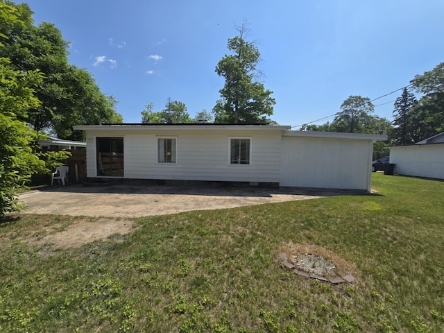 506 S N St, Alpena, MI 49707 - back of house featuring a yard and a patio