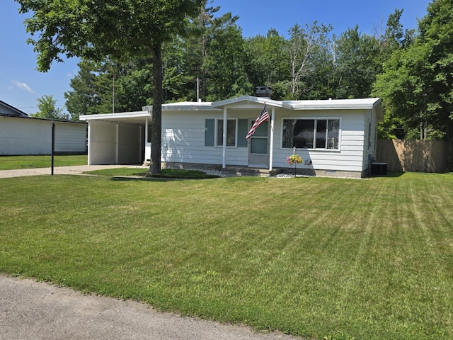 506 S N St, Alpena, MI 49707 - manufactured / mobile home with driveway and an attached carport