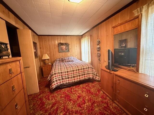 119 Ethel Dr, Roscommon, MI 48653 - bedroom featuring wooden walls, ornamental molding, and carpet flooring