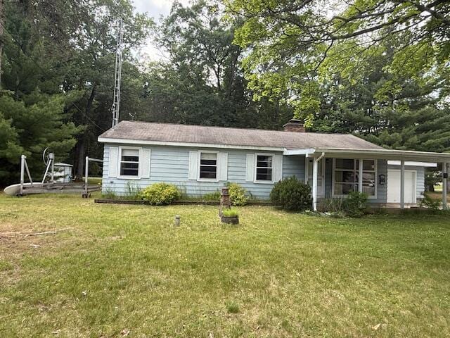 119 Ethel Dr, Roscommon, MI 48653 - view of front facade with a front yard and a chimney