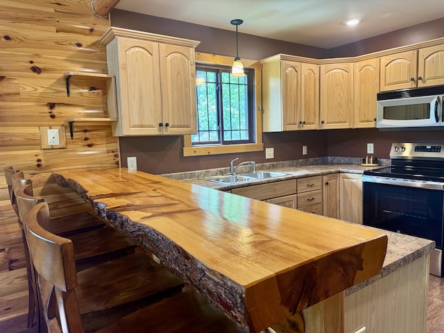 5283 Griffin Rd, Lewiston, MI 49756 - kitchen featuring stainless steel electric stove, white microwave, light brown cabinets, and wooden counters