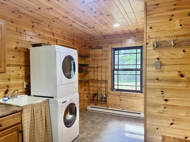 5283 Griffin Rd, Lewiston, MI 49756 - washroom featuring stacked washer / drying machine, baseboard heating, wood walls, and wooden ceiling