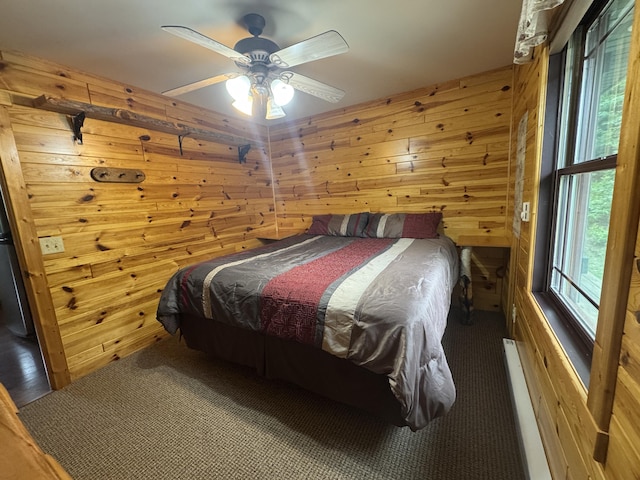 5283 Griffin Rd, Lewiston, MI 49756 - bedroom with wooden walls, carpet flooring, and ceiling fan