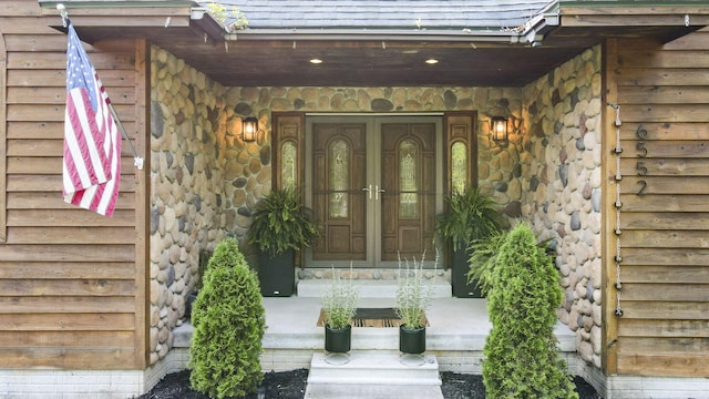 6552 High Trees Ct, Gaylord, MI 49735 - doorway to property with roof with shingles and stone siding