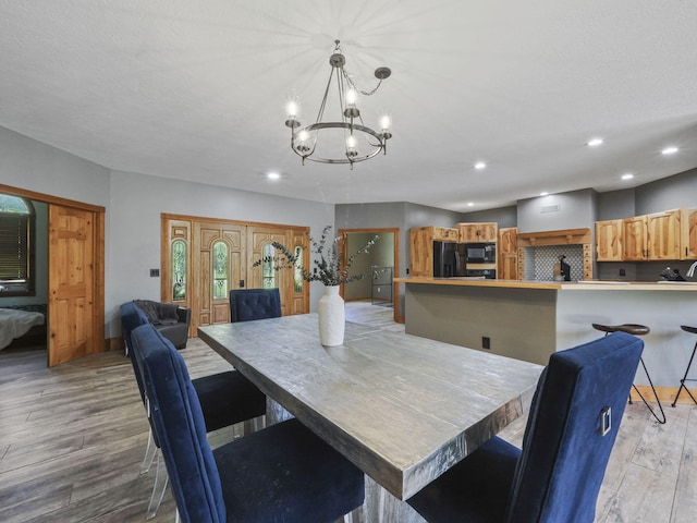 6552 High Trees Ct, Gaylord, MI 49735 - dining room featuring light wood-style flooring, a chandelier, and recessed lighting