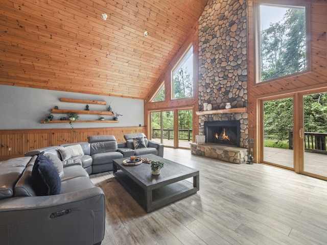 6552 High Trees Ct, Gaylord, MI 49735 - living area with high vaulted ceiling, wood ceiling, wooden walls, a fireplace, and wood finished floors