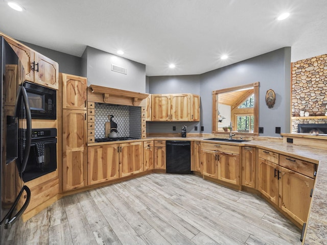 6552 High Trees Ct, Gaylord, MI 49735 - kitchen with black appliances, light wood-type flooring, light countertops, and recessed lighting