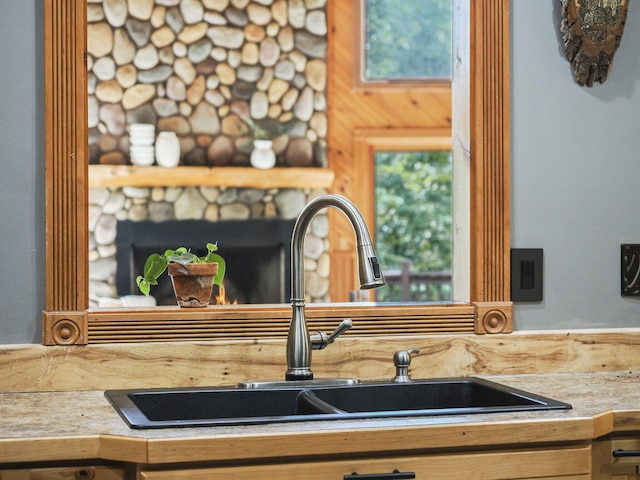 6552 High Trees Ct, Gaylord, MI 49735 - kitchen view of a sink and a fireplace
