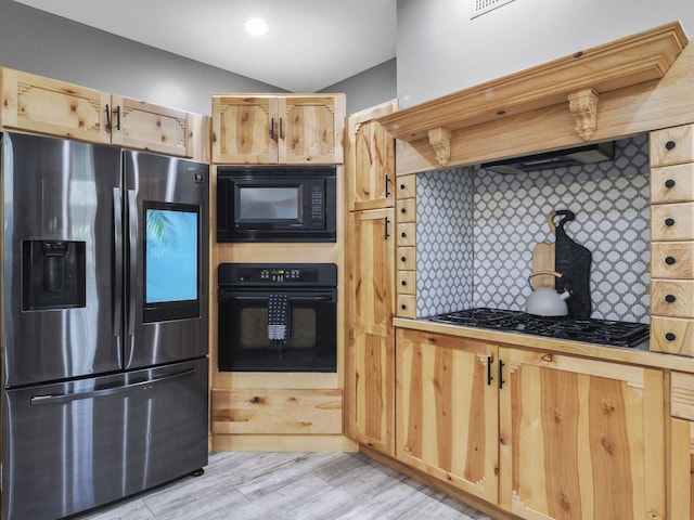 6552 High Trees Ct, Gaylord, MI 49735 - kitchen with black appliances, custom exhaust hood, light brown cabinets, backsplash, and vaulted ceiling