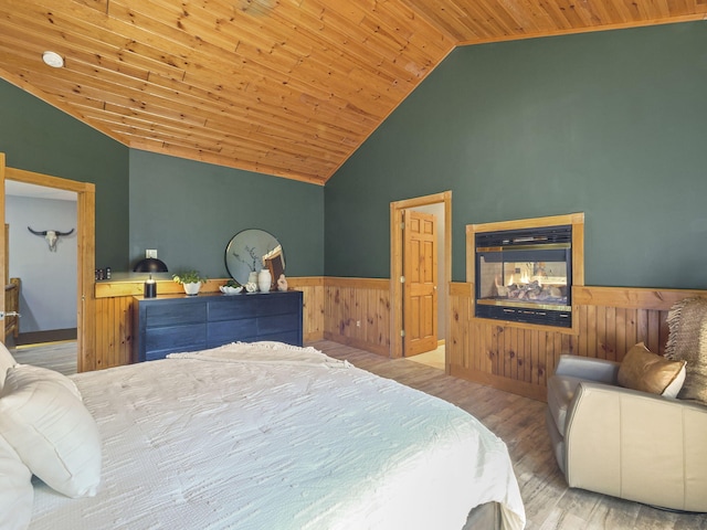 6552 High Trees Ct, Gaylord, MI 49735 - bedroom featuring wainscoting, lofted ceiling, wooden ceiling, wood finished floors, and wooden walls