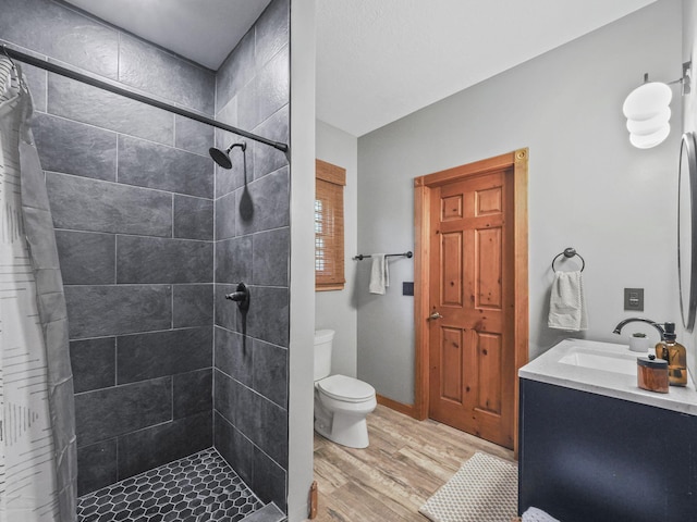 6552 High Trees Ct, Gaylord, MI 49735 - full bathroom featuring wood finished floors, vanity, and a tile shower